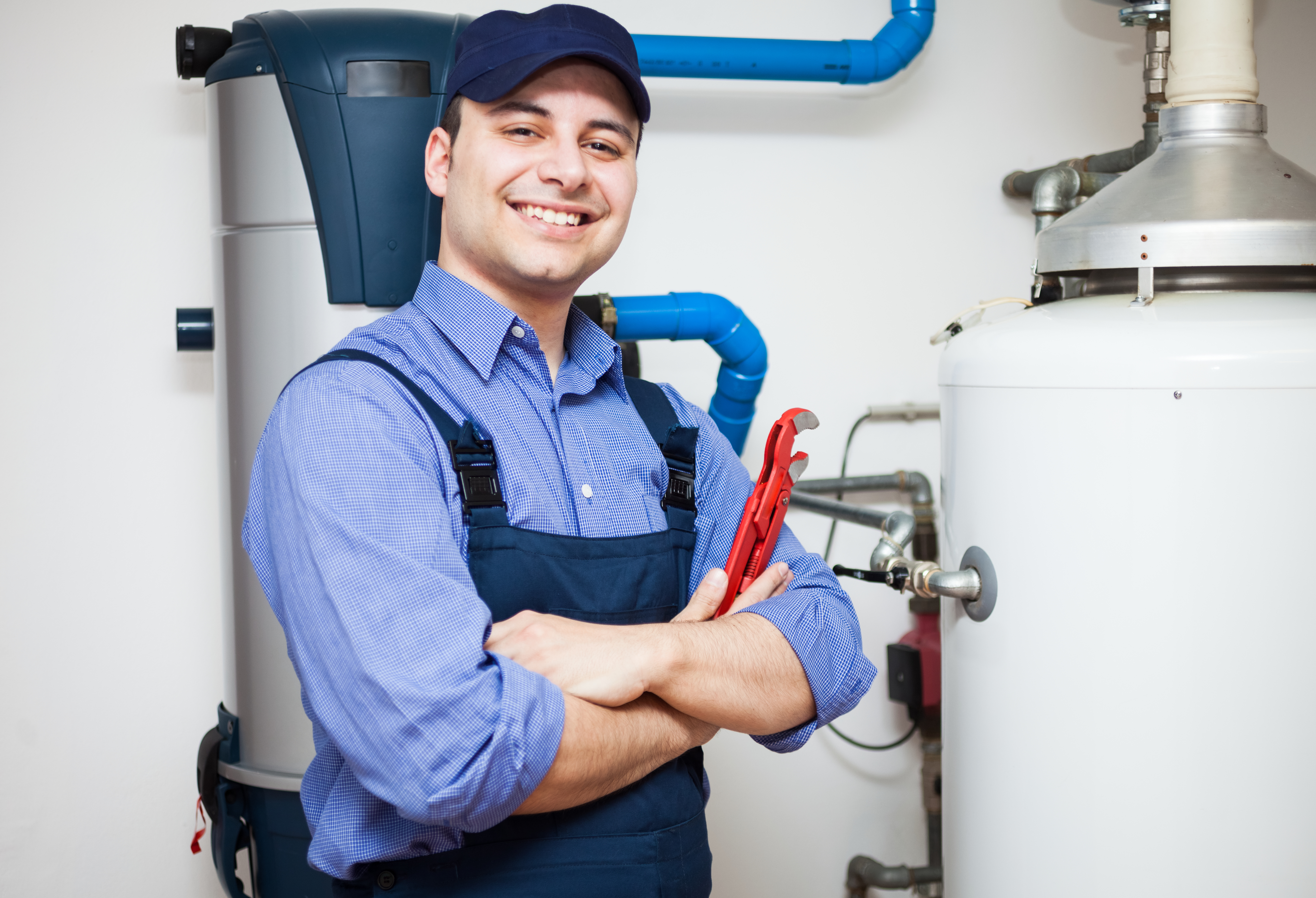 Worker standing in front of a water heater