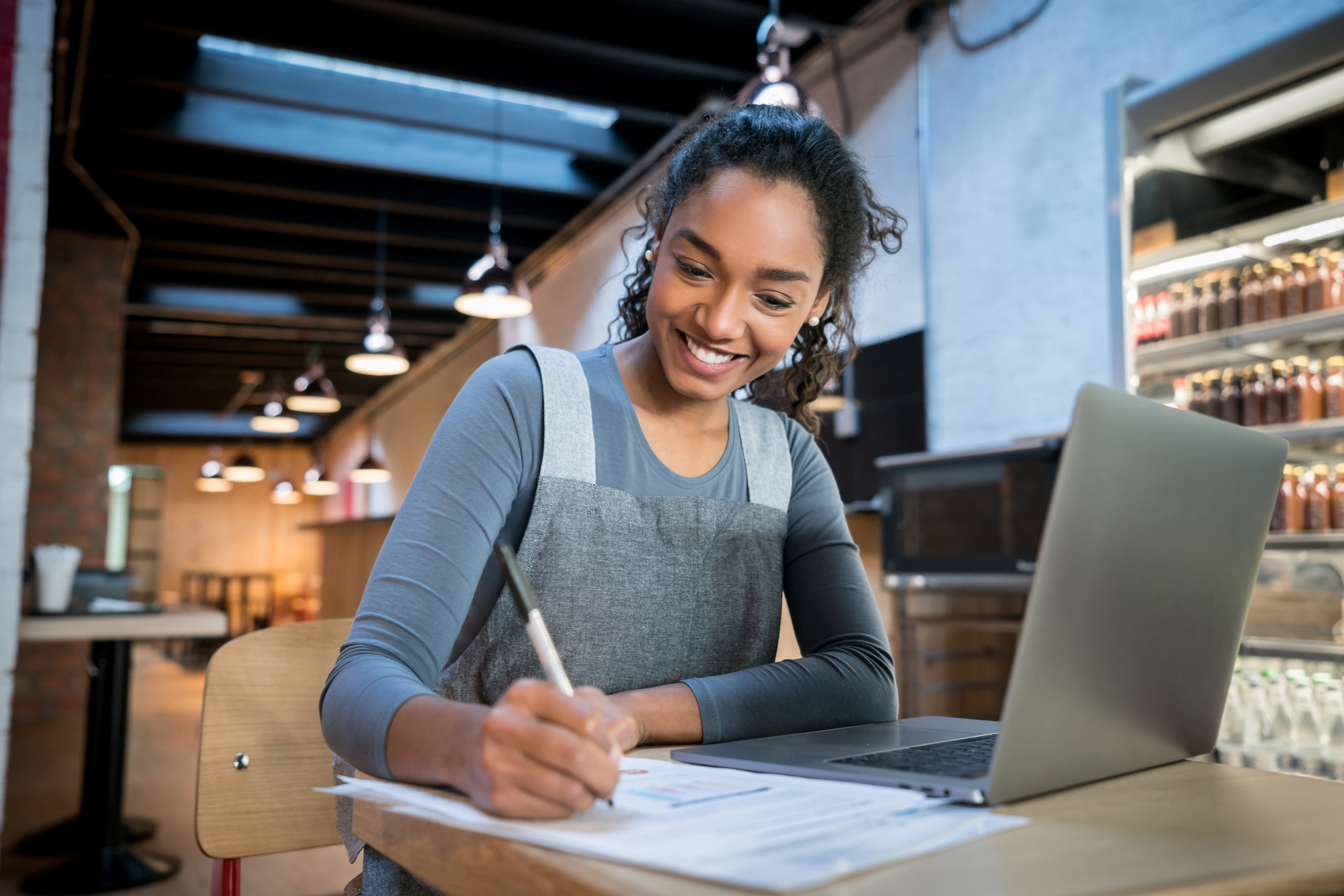 Woman working at desk with laptop