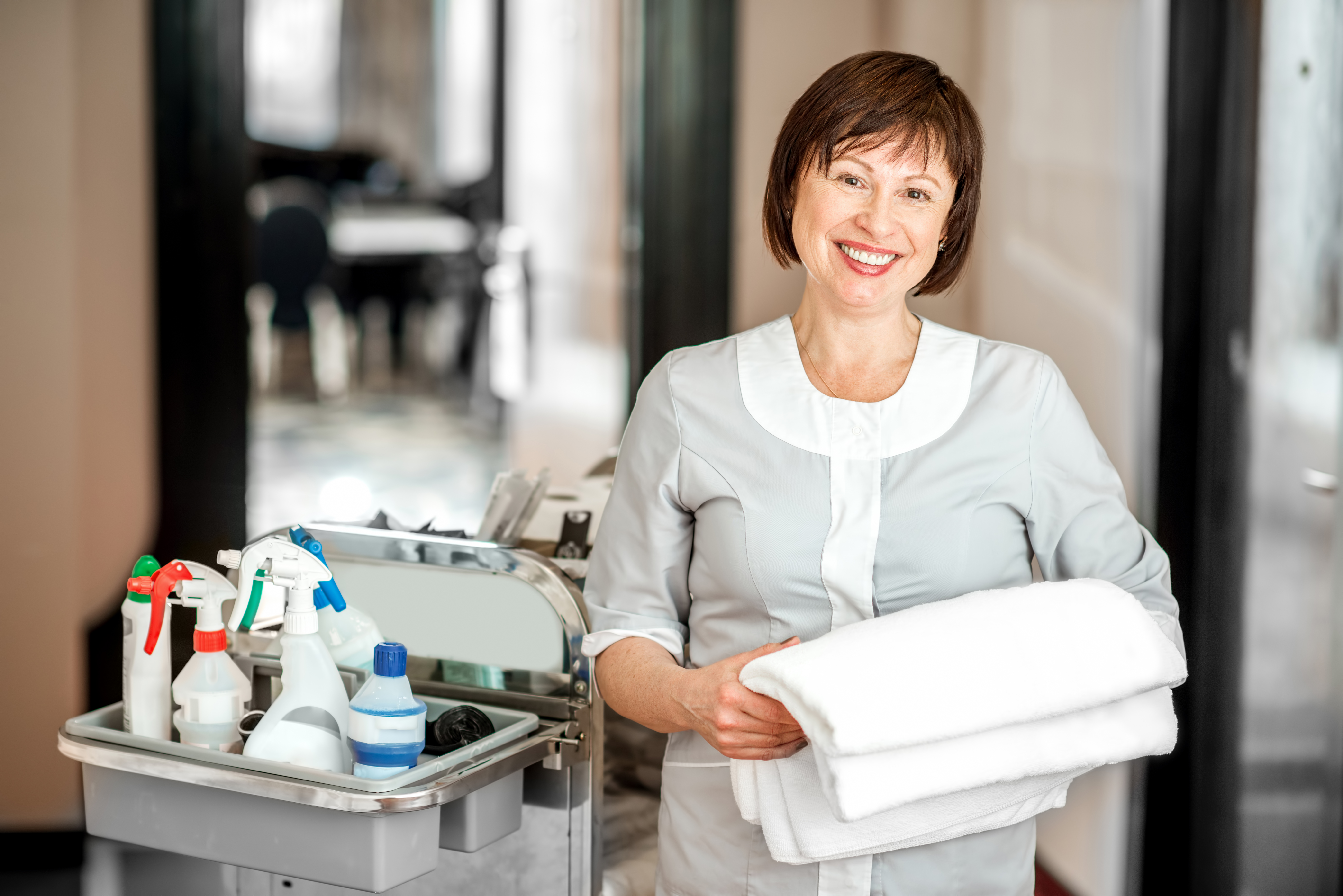 Hotel room service attendant smiling