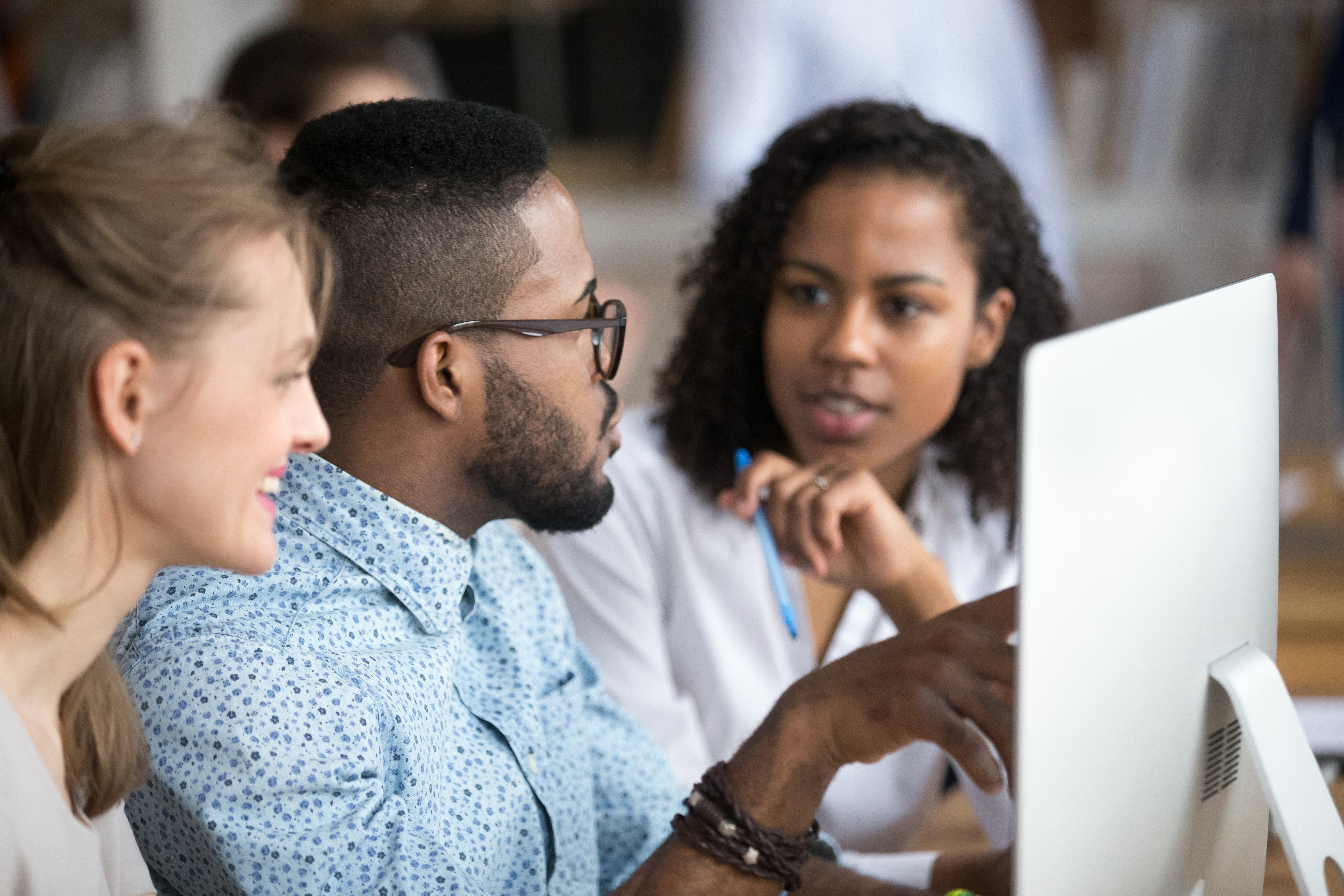 Coworkers discussing documents on the computer