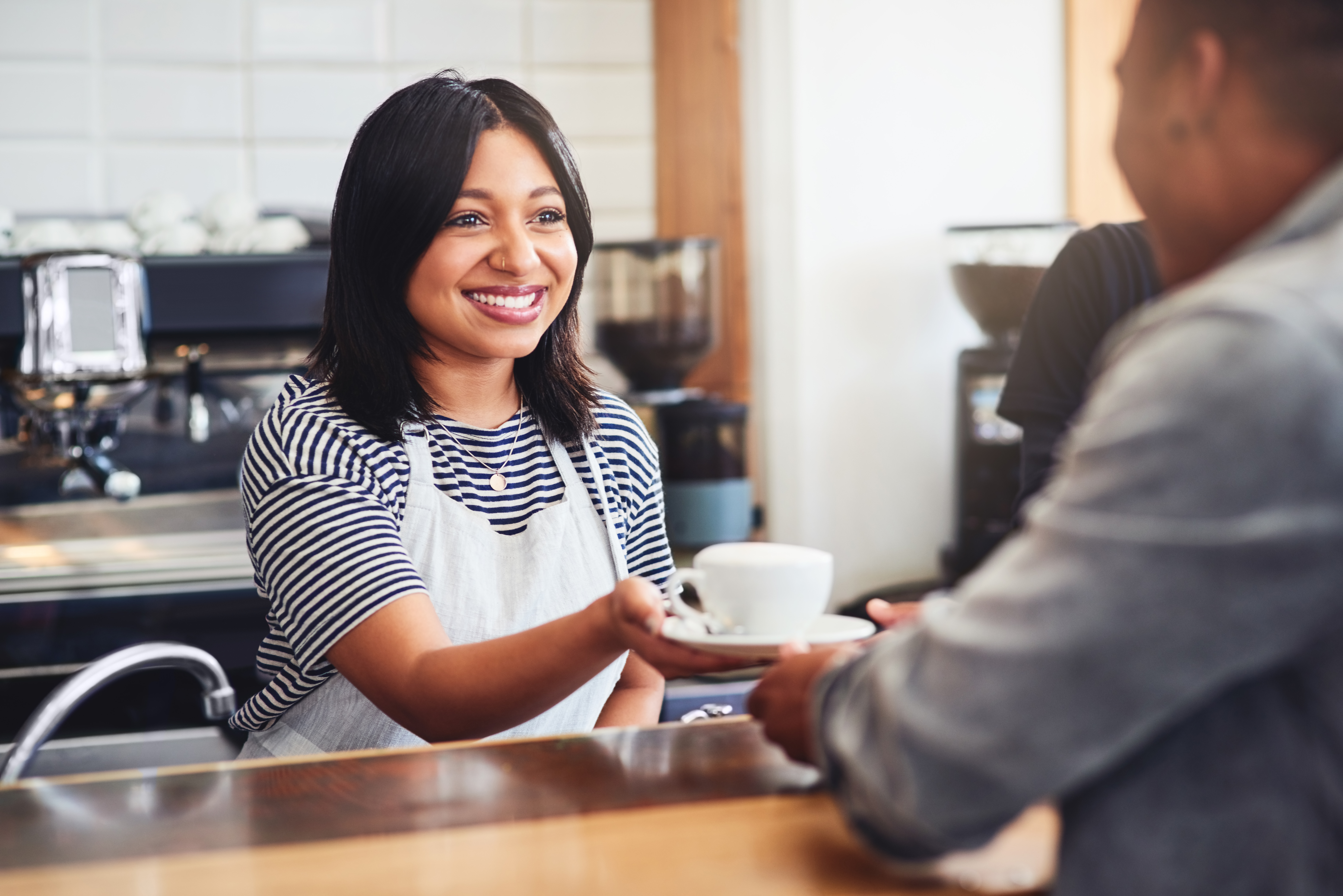 Café worker serving coffee