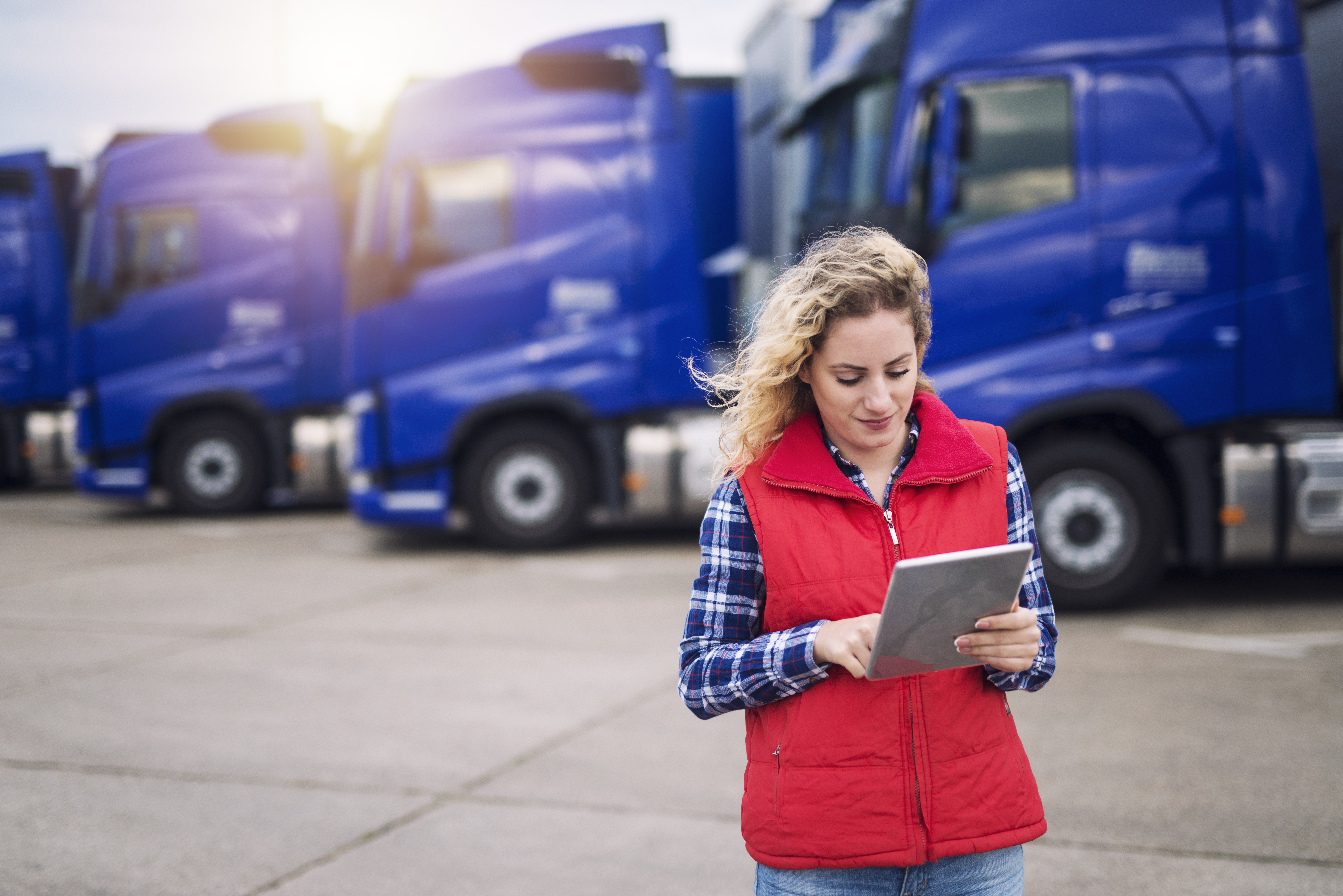 Female truck driver looking at a tablet