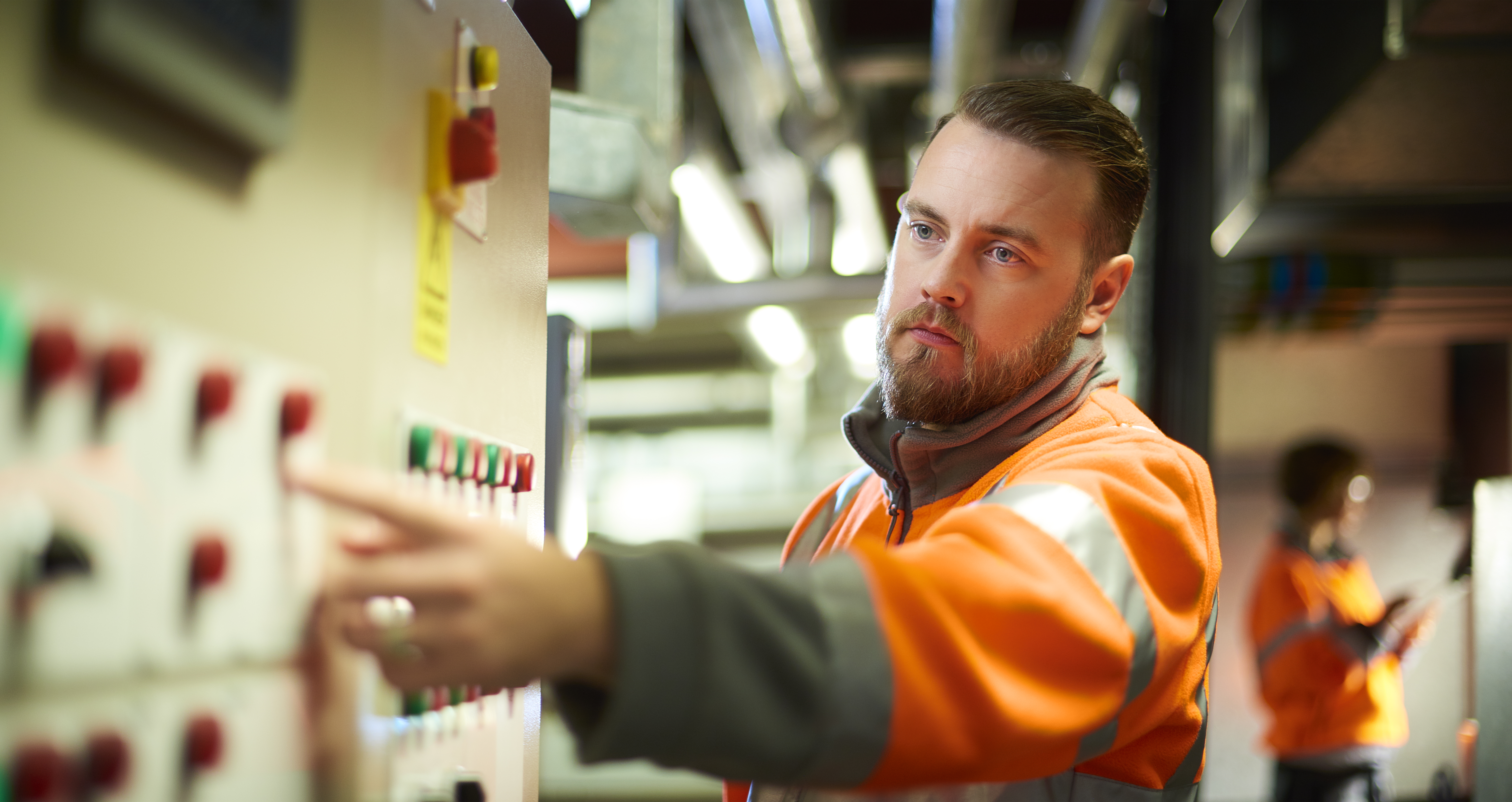 Man pointing at board, heap big important vest